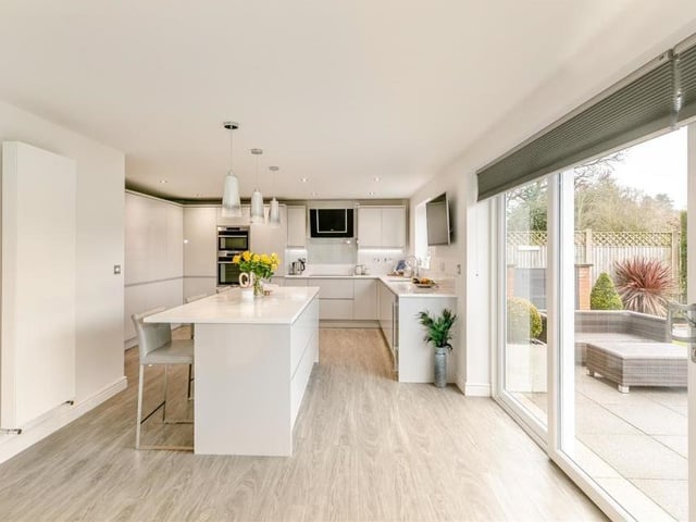 Next stop at the £635,000 property is this open-plan dining kitchen that is superbly appointed, with sliding patio doors leading out to the south-facing back garden.