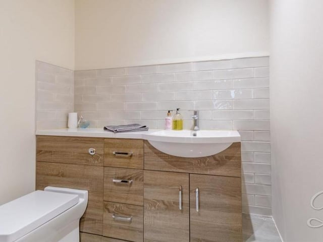 Completing the ground floor is this toilet, complete with low-flush WC and wash hand basin with vanity unit.
