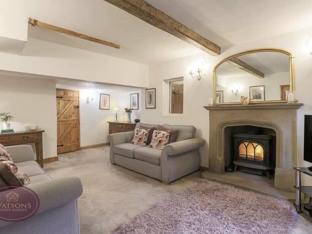 Let's start our tour of the Three Horseshoes in the lovely lounge, which is distinguished by its exposed ceiling beams and sandstone fireplace with inset multi-fuel burner.