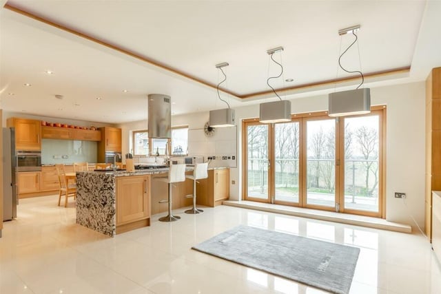 The entrance hall flows into a wonderful, large open-plan living/dining kitchen, which has doors that lead out ti the decked rear balcony. Ample ceiling spotlights and underfloor heating make it a bright and warm space.