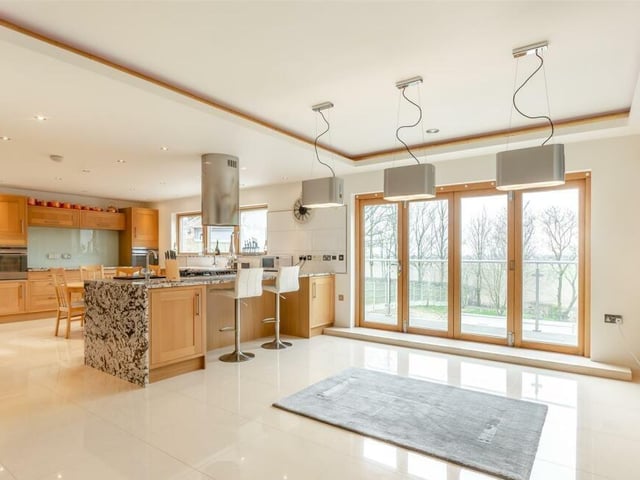 The entrance hall flows into a wonderful, large open-plan living/dining kitchen, which has doors that lead out ti the decked rear balcony. Ample ceiling spotlights and underfloor heating make it a bright and warm space.