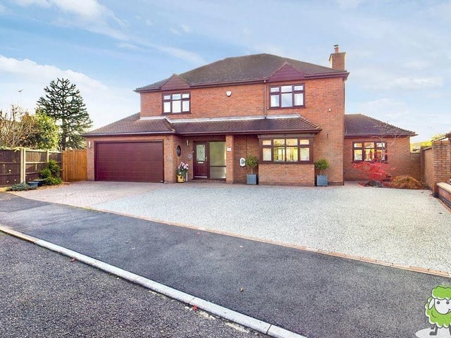 As we say farewell to the Mansfield Woodhouse property, let's return to the handsome frontage, where there is space for up to five vehicles on a large driveaway, and also a double garage with electric door.