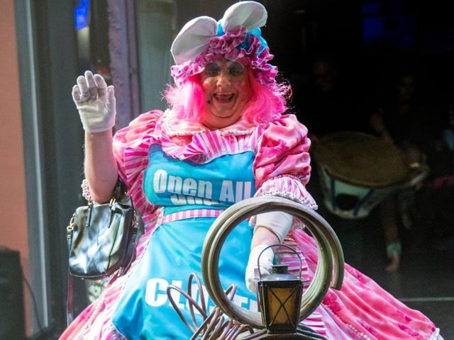 The panto Dame riding on a train during Beauty and the Beast in 2019.