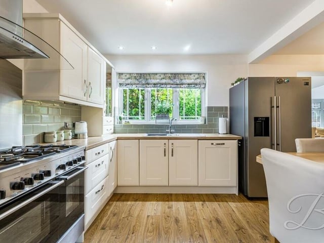 Let's open our photo gallery in the modern kitchen of the £360,000-plus Forest Town home. It offers an extensive range of contemporary, matching units and cabinetry, with complementary work surfaces over and an inset sink.