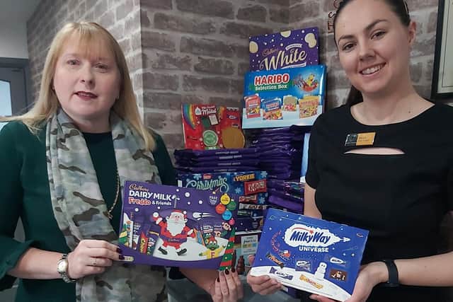 Salon owner Hayley Wood (left) and manager Alanya Jennings with some of the selection boxes that Wood's Of Westgate has collected so far.