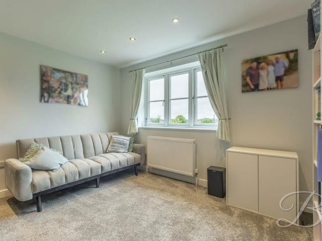 All five bedrooms are versatile and could be converted into something else. This one has fitted carpets and space for furniture, including a sofa, and storage.