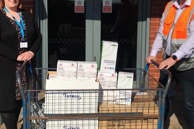 Defibrillators being handed over by Build Manager, Mike Attfield, before being distributed to St John Ambulance.