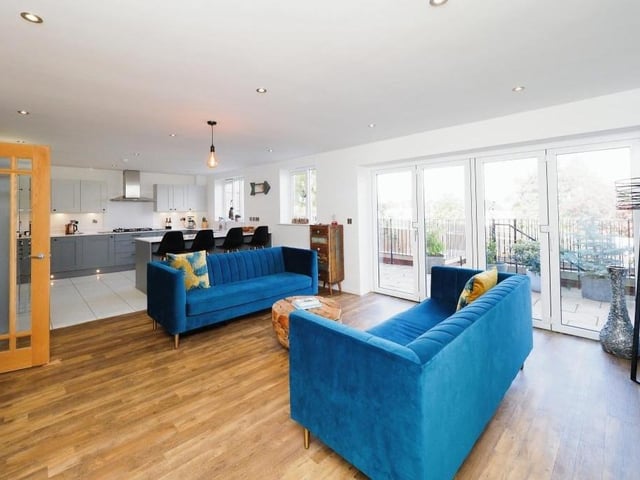 We start our tour of the Wildflower Rise property in the open-plan area of the ground floor which links the kitchen/diner with this family room. A nice relaxing spot with French doors leading to the back garden.