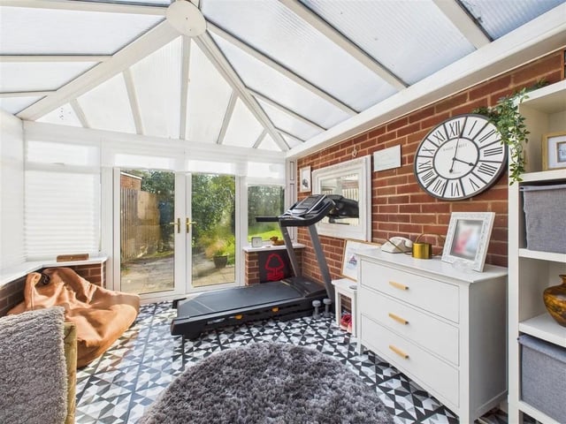 A lovely light filled conservatory with views down the garden through the feature French doors.