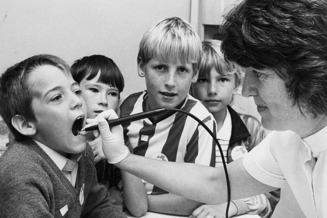 Dentist Penelope Vasey is pictured demonstrating the use of a plaque removal machine to schoolboys, left to right: Anthony Fake, Jonathon Mallen, Neil Williamson and Brian Campbell, third year pupils at St Gregory's, South Shields.  Pupils from the school visited the dental surgery open day, to learn about oral hygiene and dental practice to help remove the fear of a visit to the dentist.