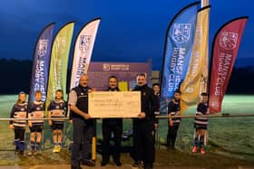 Mansfield Rugby Club are presented with the new flags and a cheque for £850.