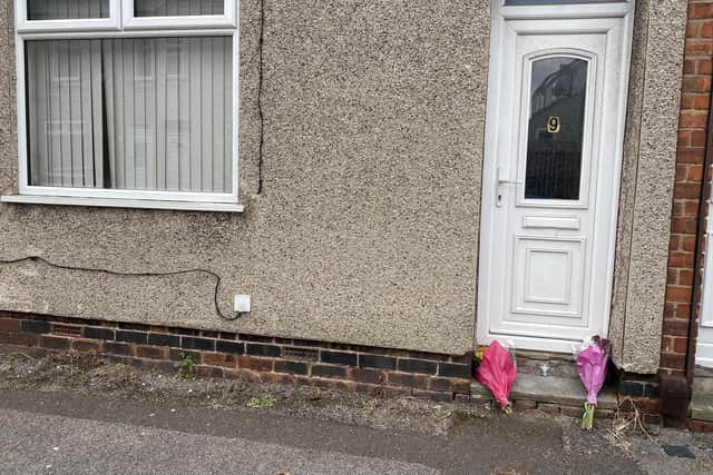 Flowers have been left outside the house on George Street, Mansfield