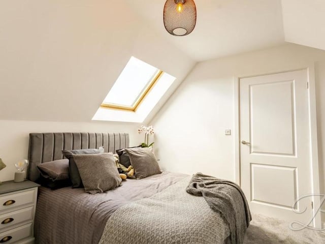 The remaining two bedrooms at the £500,000 property sit on the first floor. Here is one of them, with a carpeted floor and window to the back. It has access to an en suite bathroom.