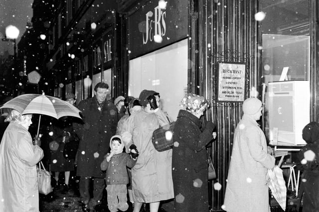 Shoppers brave the snow to queue for the Christmas sale at J & R Allan's on the Bridges.