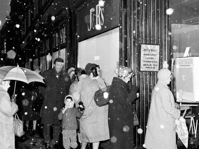 Shoppers brave the snow to queue for the Christmas sale at J & R Allan's on the Bridges.