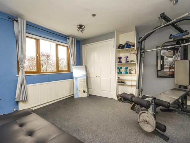 A second look at the bedroom-turned-gym. This shot shows how bright it is and how it is fitted with wardrobes.