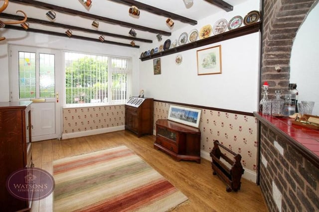 The dining room, which comes with a fitted bar, is an attractive space. Features include a wood-effect laminate floor and a window facing the front of the £375,000-plus bungalow.