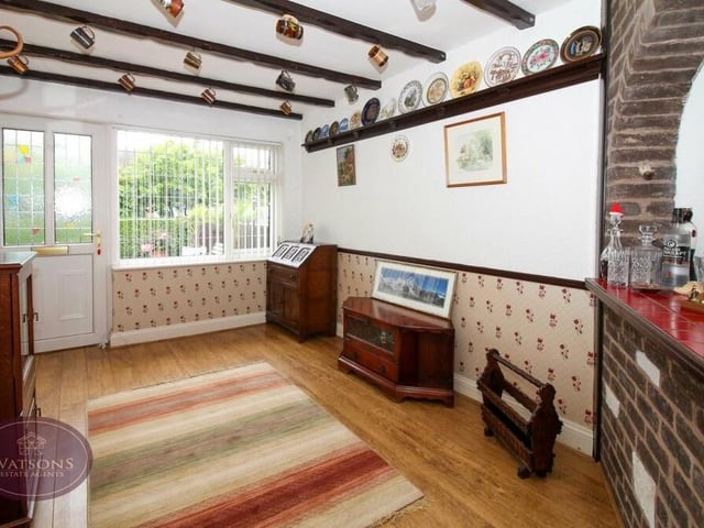 The dining room, which comes with a fitted bar, is an attractive space. Features include a wood-effect laminate floor and a window facing the front of the £375,000-plus bungalow.