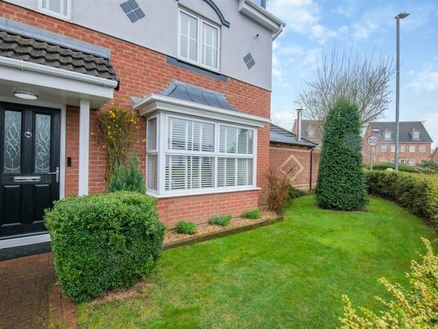 Let's return to the front of the house, where there is a small but neat, enclosed garden, with a lawn and a block-paved pathway that leads to the entrance door.
