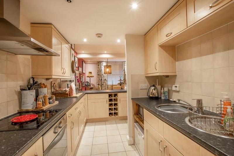 The kitchen features a range of Shaker-style units and roll edge worktops incorporating new appliances including an oven with a new ceramic hob, an under-counter fridge and freezer, a washing machine, a dishwasher and integrated microwave. The kitchen also features a peninsula unit and breakfast bar.