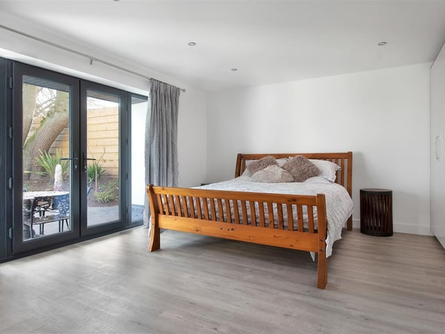 Having contemporary high gloss fitted wardrobes, underfloor heating and French doors leading out onto the front elevation affording pleasant easterly open views over adjacent countryside.