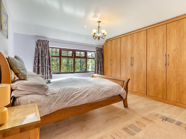 As you can see, the master bedroom is blessed with substantial fitted wardrobes that have hanging rails and shelving.