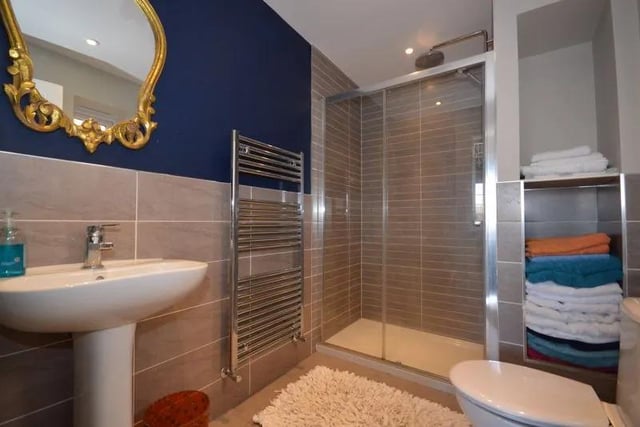 The en-suite, one of three bathrooms, features shower and toilet.