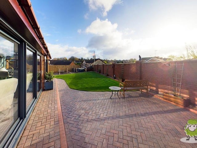 This shot shows how the sliding doors at the back of the house open on to a patio that is ideal for relaxing in the sun.