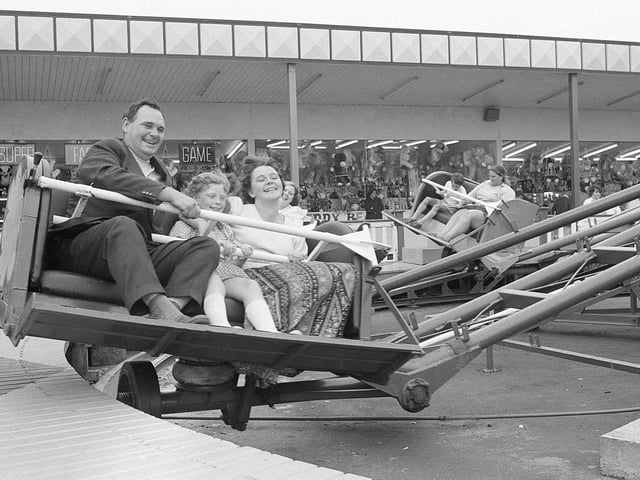 A family enjoys a funfair ride in Clipstone in 1973.