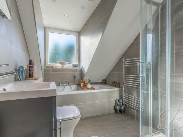 To complete our tour of the first floor, let's take a quick peek at the gorgeous family bathroom. It consists of a panelled bath, shower cubicle, vanity hand wash basin, low-flush WC and full-height tiling.