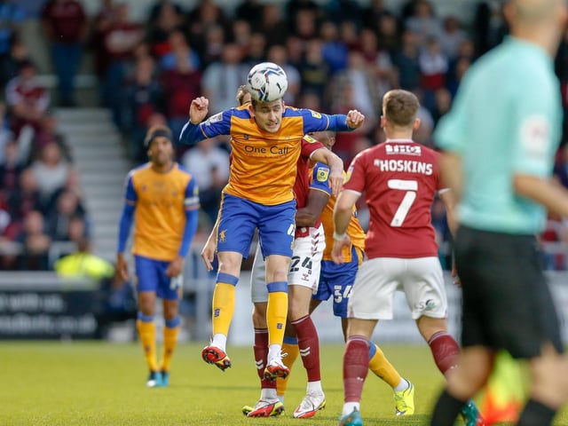 Mansfield Town defender Elliott Hewitt heads forward.
