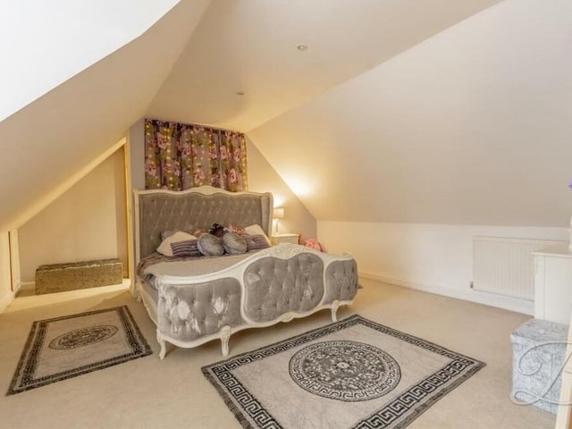 The master bedroom on the first floor has a touch of elegance about it. There are downlights and a window to the front of the property.