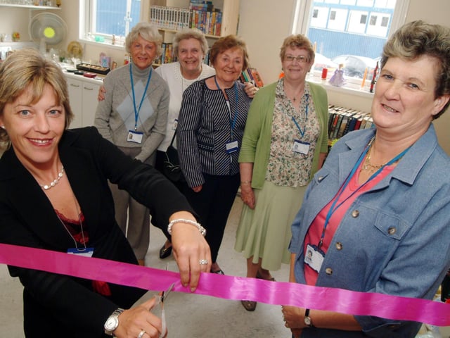 King's Mill Hospital volunteers relaunched the Charity Shop in the main reception, Trust Chairman Tracy Doucet, left, cut the ribbon with Charity Shop co-ordinator Eve Booker, right, watched by Charity Shop volunteers, from the left; Marjorie Grice, Mary Abell co-ordinator, Sheila Whalley and Barbara Lewis.