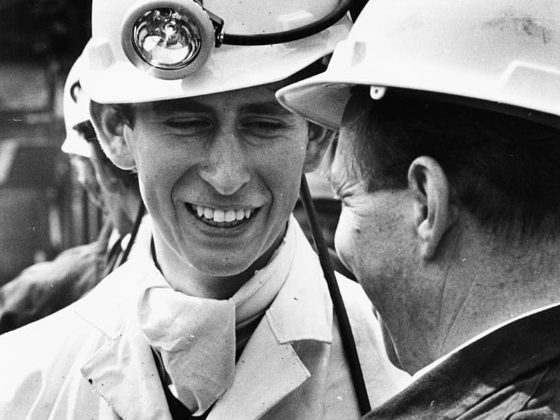 Prince Charles wearing a miners helmet and white overalls as he talks to a miner during a visit to Welbeck Colliery on July 19th 1968.