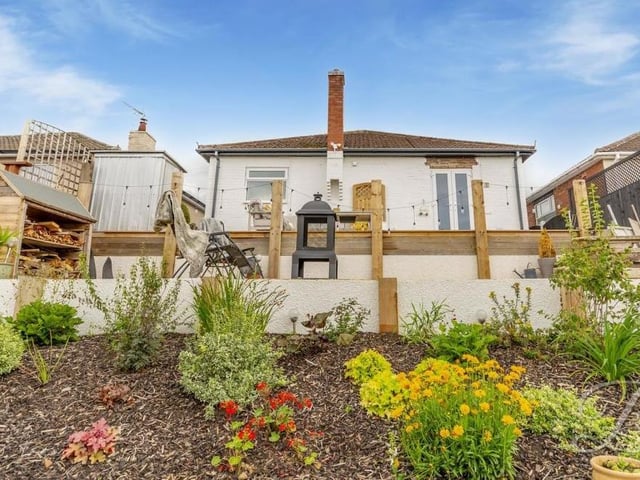 Let's move outside now and take a look at the bungalow from the back. This photo shows how the rear garden is cleverly tiered.