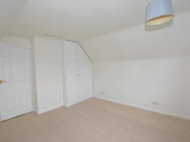 Moving on to the first floor, here is the main bedroom that overlooks the back of the bungalow. A double wardrobe and dressing area could easily be converted into an en suite, if required.