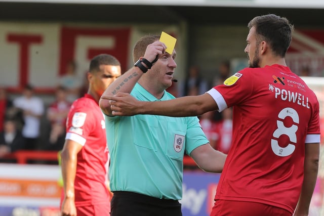 Referee Lee Swabey shows a yellow card to Jack Powell of Crawley Town. It was one of 71 bookings and four reds for the club.