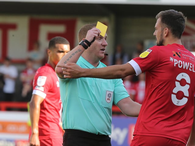 Referee Lee Swabey shows a yellow card to Jack Powell of Crawley Town. It was one of 71 bookings and four reds for the club.