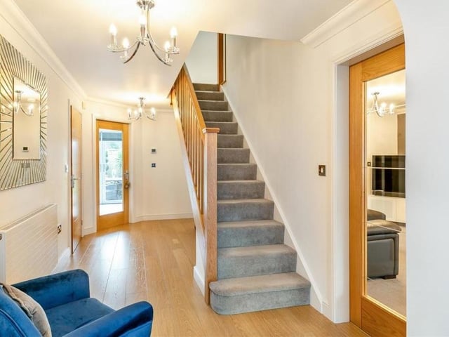 It's time to go upstairs now at the Mayflower Court house, which means we need to pass through this smart entrance hall. As well as the staircase, it boasts a laminate floor and underfloor heating, which is controlled via a pad on the wall.