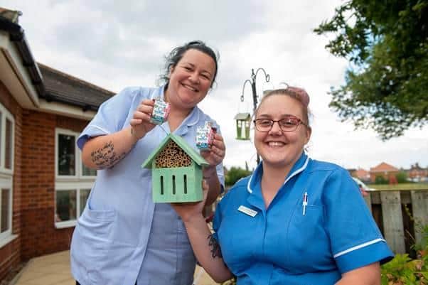 The team at Nightingale Nursing and Care Home accepting the butterfly home donation.