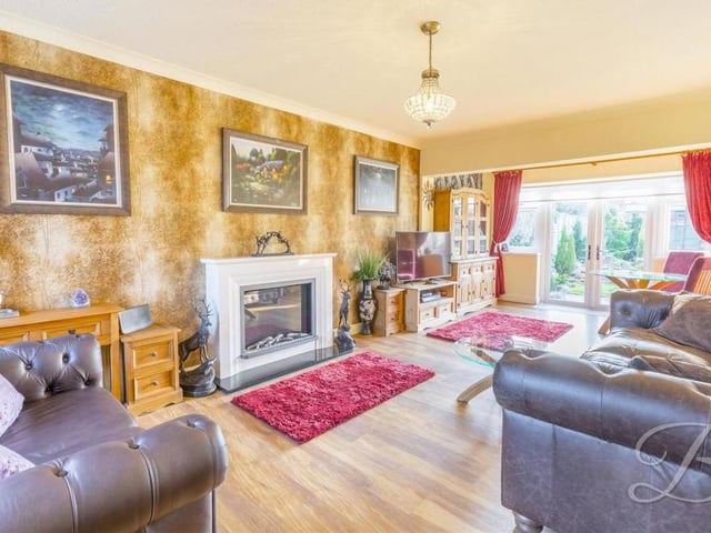 The first room we look at in the Denby Drive bungalow is this luxurious lounge, which radiates homeliness, particularly with its feature fireplace. The floor is laminated, while a large set of French doors lead out to the back garden.
