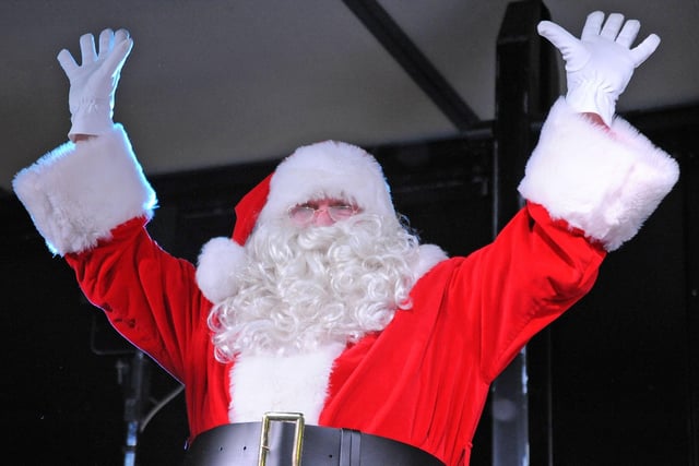 Santa gives the crowd a wave on his arrival to the Christmas festival