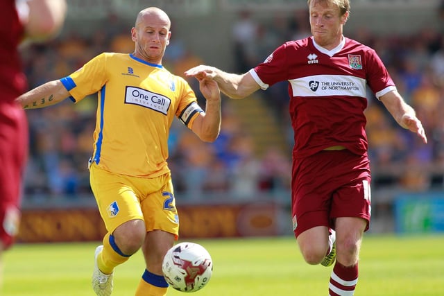 Adam Murray in a midfield duel during a 1-0 defeat in 2014.