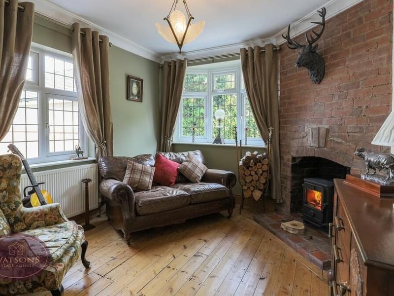How about this for the cosiest of sitting rooms? With windows to the side and rear, features include exposed wooden flooring and a brick-built chimney breast with inset multi-fuel burner.