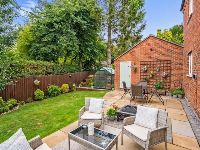 Let's take a quick look outside, particularly at the attractive back garden, which is surrounded by trees, bushes and shrubs and features a lovely patio area for seating.