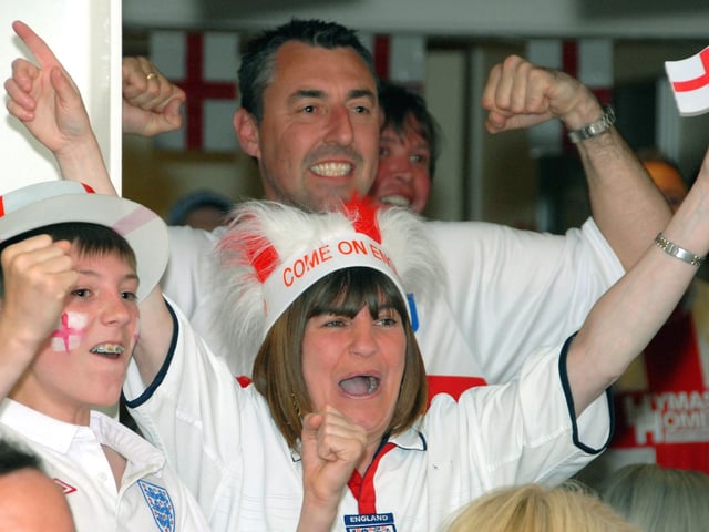 Mansfield Town staff and fans watch England's opening game in the 2010 World Cup.