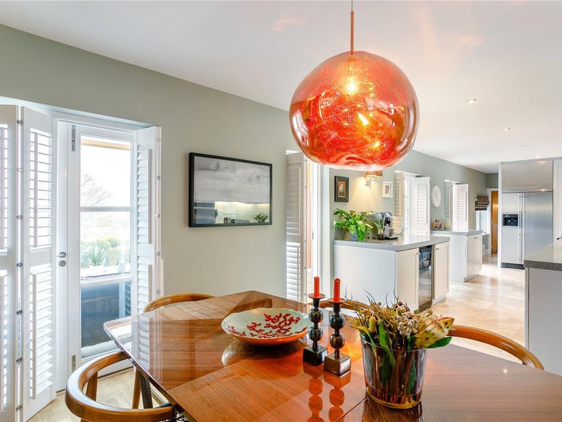 The dining area is open-plan to both the kitchen and sitting room, laid with an oak floor and with entry to the garden room via French doors.