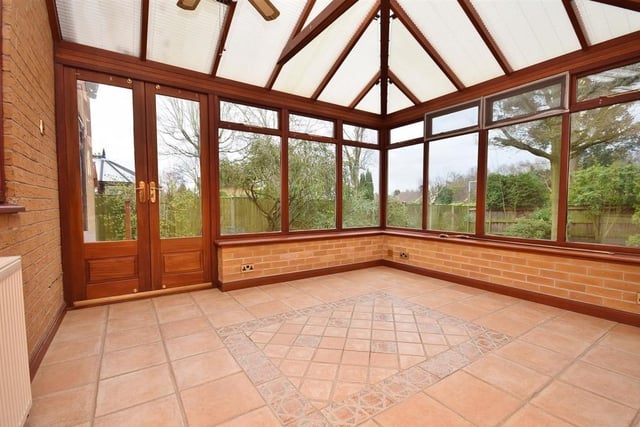 The light-filled conservatory offers a panoramic view of the stunning back garden, with uPVC windows to the side and rear, plus uPVC doors leading straight on to the patio. The floor is tiled.