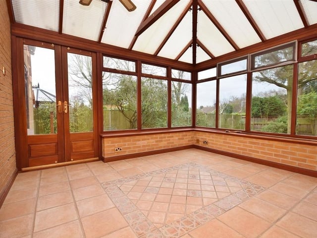The light-filled conservatory offers a panoramic view of the stunning back garden, with uPVC windows to the side and rear, plus uPVC doors leading straight on to the patio. The floor is tiled.