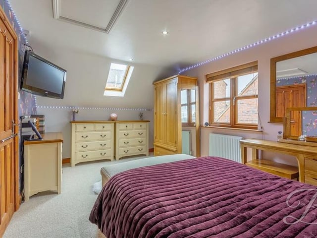 The third bedroom from a different angle, showing what a comfortable retreat it is. There is ample storage space, and a Velux window adds extra light.